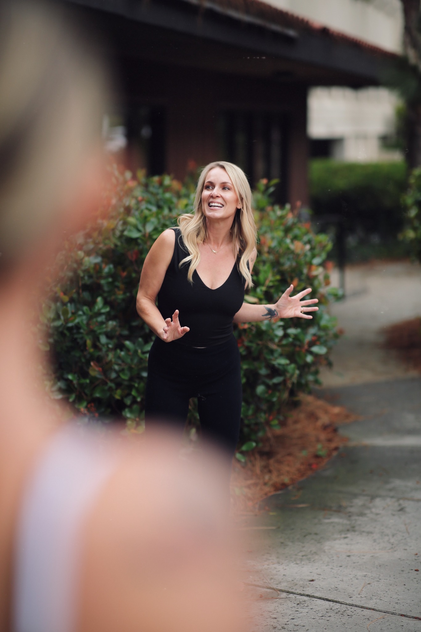 Kali May guiding a group breathwork experience outdoors