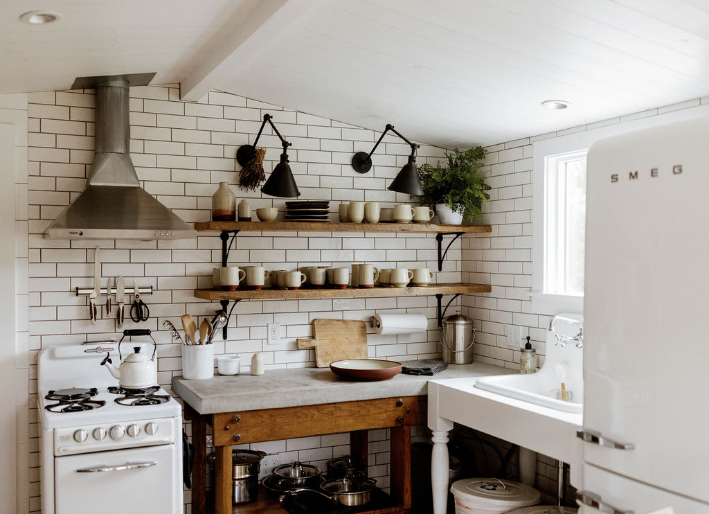 A warm working kitchen filled with handmade ceramics and natural materials