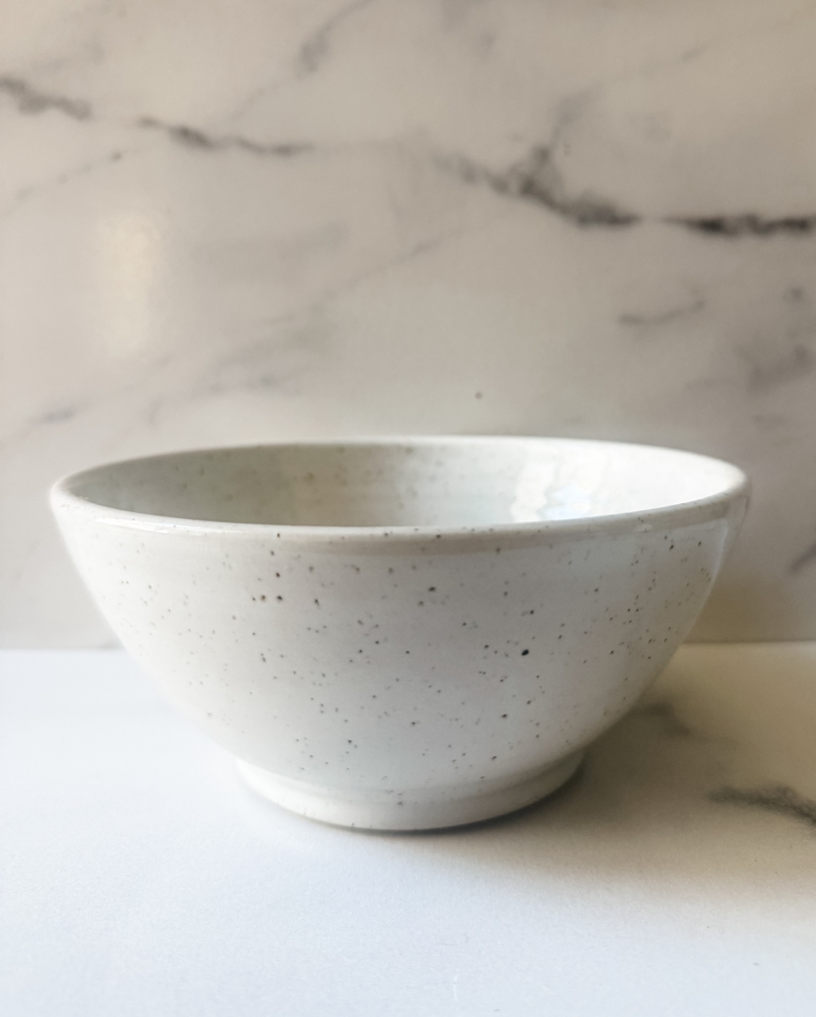 Speckled white handmade bowl from the Nest Collection